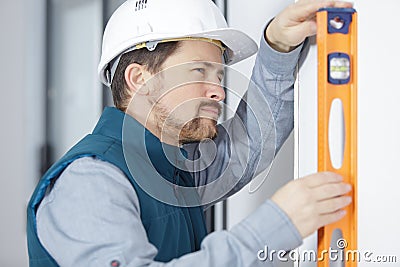 conscientious workman using spirit level Stock Photo