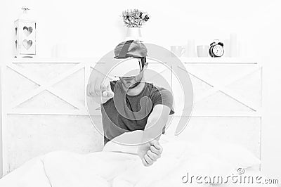 Conscious awakening. Return to reality. Man explore vr while relaxing in bed. Awakening from virtual reality. VR Stock Photo