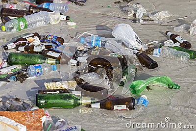 Consequences sea water pollution on the beach after full moon party in Thailand. Close up Editorial Stock Photo