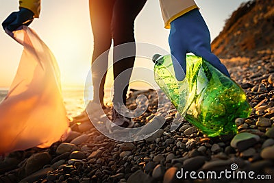 Conservation of ecology and Earth Day. A volunteer collects plastic bottles by the sea. Coastal cleanup for recycling Stock Photo