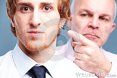 Conservative businessman pointing to an earring Stock Photo