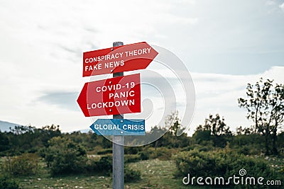 Conspiracy theory, fake news, Covid-19, panic, lockdown, global crisis road warning signs. Social media campaign for Stock Photo