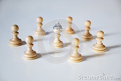 Conspiracy theory and manipulation concept in coronavirus time, group of pawn chess pieces are surrounding a piece with a tinfoil Stock Photo