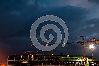 Constraction site with a crane at night Stock Photo