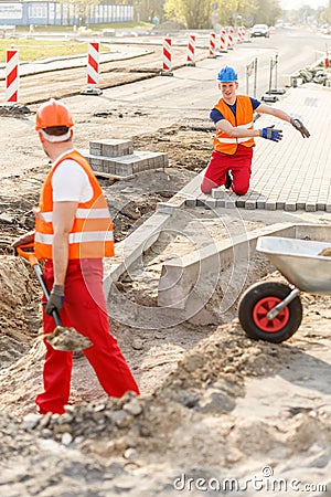 Construcion workers laying brick pavement Stock Photo