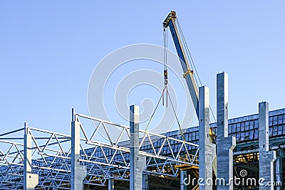 Construction of the body of a modern factory, assembly of metal trusses Stock Photo