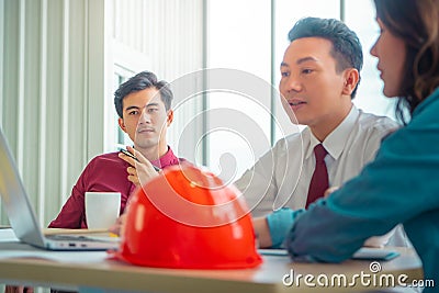 Construction Boss with business man engineer architect is discussing project details on laptop computer Stock Photo