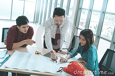 Construction Boss with business engineer and architect is discussing on working table with building plan Stock Photo