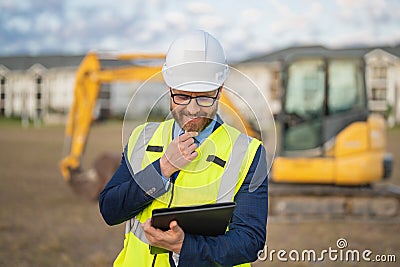 Construction builder manager or supervisor at a construction site. Portrait of construction manager worker in hardhat Stock Photo
