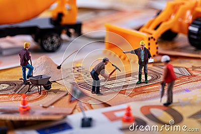 Construction business concept - workers team working hard to earn more money Stock Photo