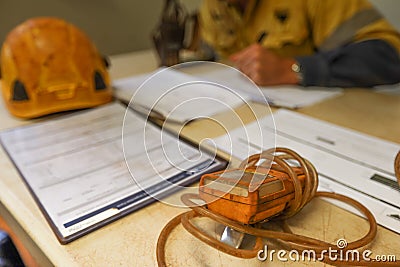 Construction coal miner supervisor conducting safety checking on job hazards analysis on confined space permit before sign off Stock Photo