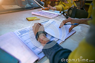 Construction coal miner supervisor conducting safety checking on job hazards analysis on hot work permit before sign off Stock Photo