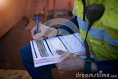 Construction coal miner supervisor conducting safety checking on job hazards analysis on hot work permit before sign off Stock Photo