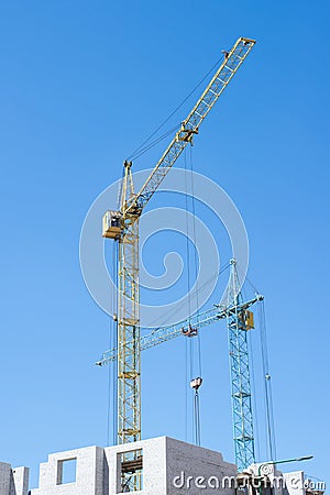 Construction crane on blue sky background Stock Photo