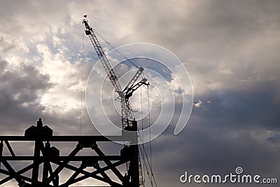 Construction crane early on a cloudy morning Stock Photo