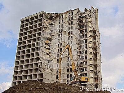 Construction crane in front of a half demolished apartment tower Editorial Stock Photo