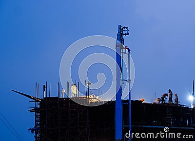 Construction crane truck working on structure at night Editorial Stock Photo