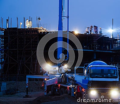 Construction crane truck working on structure at night Editorial Stock Photo