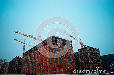 Construction cranes building house premise Stock Photo