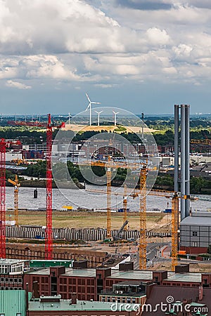 Construction cranes and wind turbines in Hamburg Stock Photo