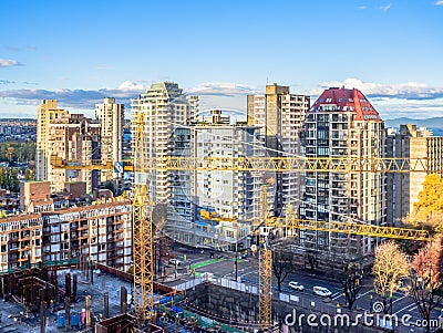 Construction cranes working in downtown Vancouver, BC, Canada Editorial Stock Photo