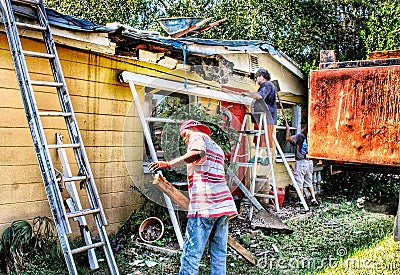 Construction crew dismantles a porch during a roofing job Editorial Stock Photo