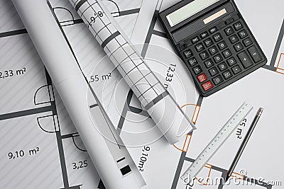 Construction drawings, ruler, pencil and calculator on house plan, flat lay. Architect workspace Stock Photo