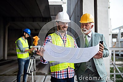 Construction engineer with foreman worker checking construction site Stock Photo