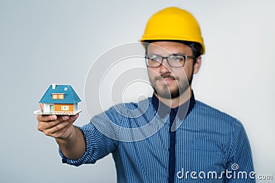 Construction engineer showing small house model Stock Photo