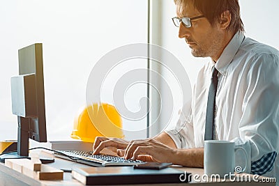 Construction engineer working on desktop computer using CAD soft Stock Photo