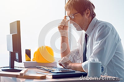 Construction engineer working on desktop computer using CAD soft Stock Photo