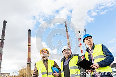 Construction engineers examining thermoelectric power station. Stock Photo