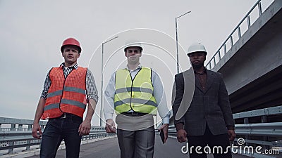 Construction engineers walking on highway ramp Stock Photo