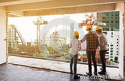 3 construction engineers working together discuss with blueprint Stock Photo