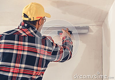 Construction Finishing Worker Patching Drywall Stock Photo