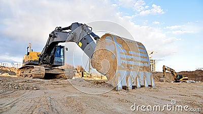 Construction of foundation excavator works in sand pit. Groundworks, site levelling, construction of reinforced ground beams Stock Photo