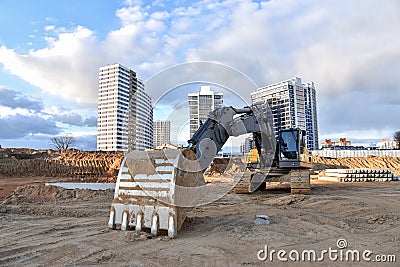Construction of foundation excavator works in sand pit. Groundworks, site levelling, construction of reinforced ground beams on Stock Photo