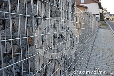 construction of a gabion retaining wall, as part of the house fencing. Stock Photo