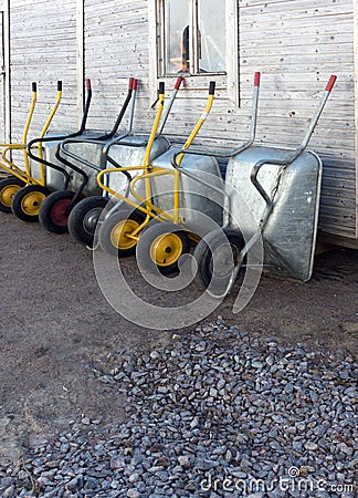 Construction handcars leaning against a wooden wall Stock Photo