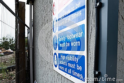 Construction Health and Safety sign seen attached to a small office. Editorial Stock Photo