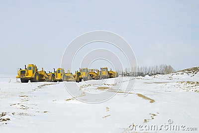 Construction Heavy Equipment parked in a Row Stock Photo