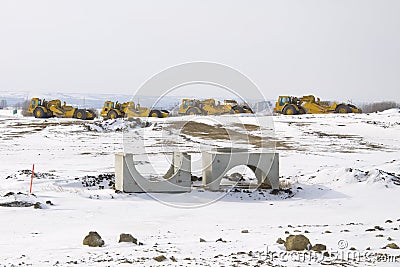 Construction Heavy Equipment parked in a Row Stock Photo