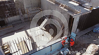 Construction Industry, Monolithic Frame Technology. Top View Of Employees Being Busy With Construction Works. Builders Editorial Stock Photo