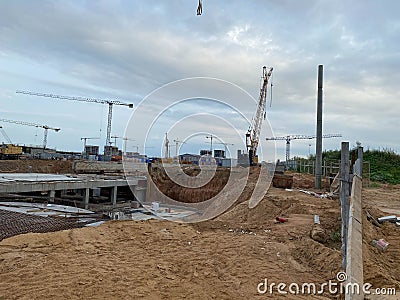 Construction of a large underground infrastructure industrial facility with a foundation using powerful construction cranes Stock Photo