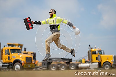 Construction man excited jump with helmet. Builder in helmet outdoor portrait. Worker in hardhat. Construction engineer Stock Photo