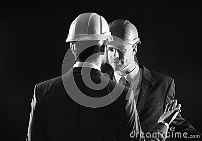 Construction management concept. Engineers isolated on black background. Stock Photo