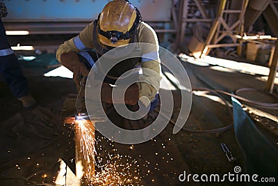 Construction miner worker wearing long sleeve t shirt, safety steel cap boot, hard hat, face shield safety protection commencing a Stock Photo