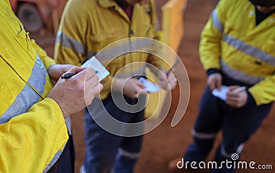 Construction miner workers conducting self risk assessment call as take five step prior to work Stock Photo