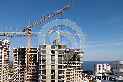 The construction of a multi-storey modern house on the seashore. Installation of floor reinforcement. Tower cranes. September 9, Editorial Stock Photo