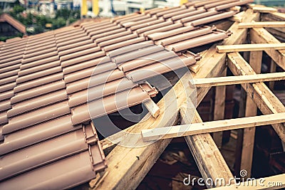 Construction of new house, roof building with brown tiles and timber. Contractor building roof of new house Stock Photo
